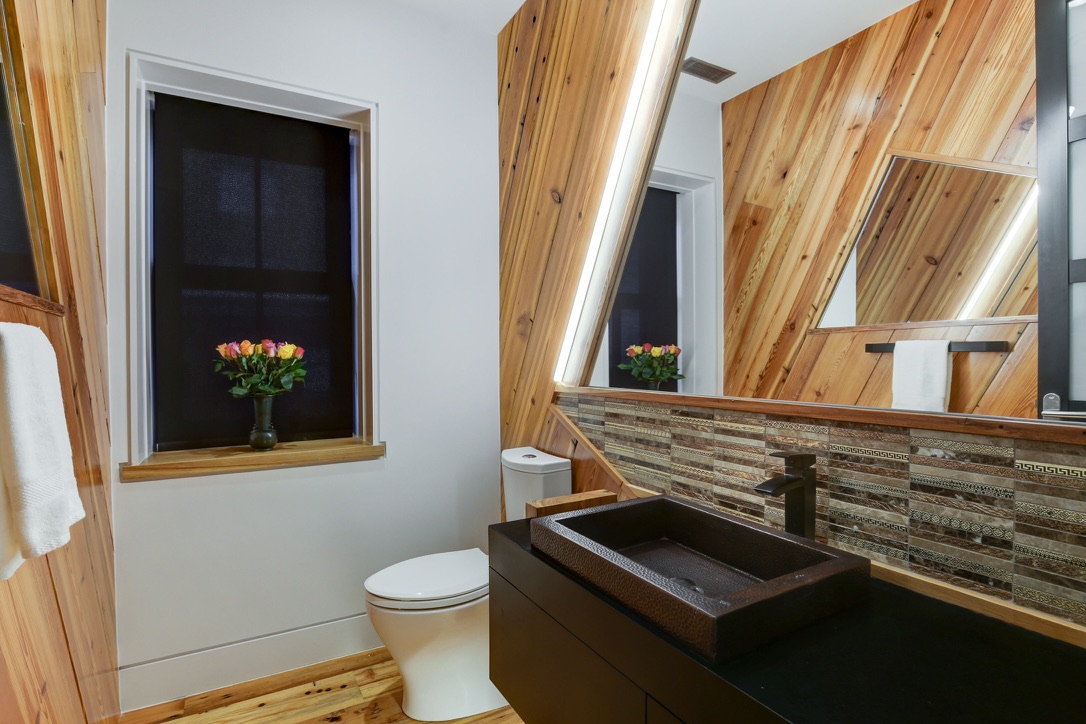 Modern bathroom with large mirror stylish vanity and updated fixtures remodeled by BBA Construction in Park City Utah
