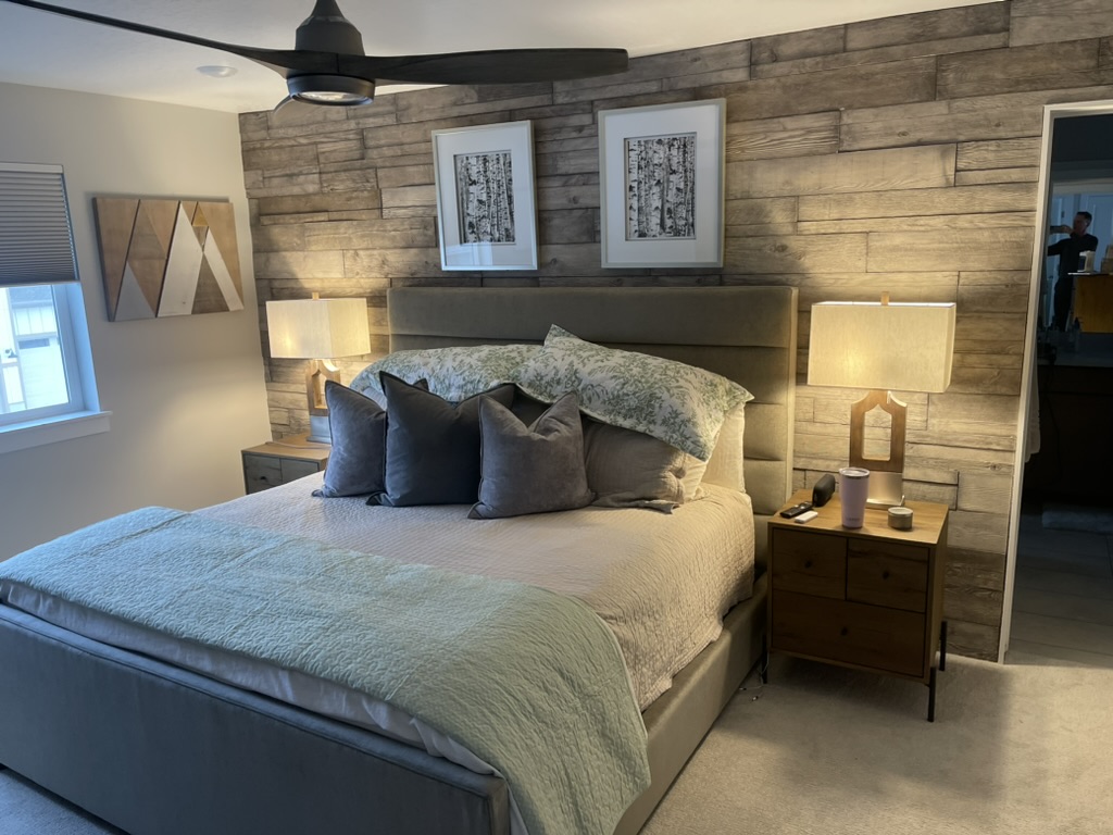 Modern bedroom with stylish bed layered textiles and contemporary decor remodeled by BBA Construction in Park City Utah