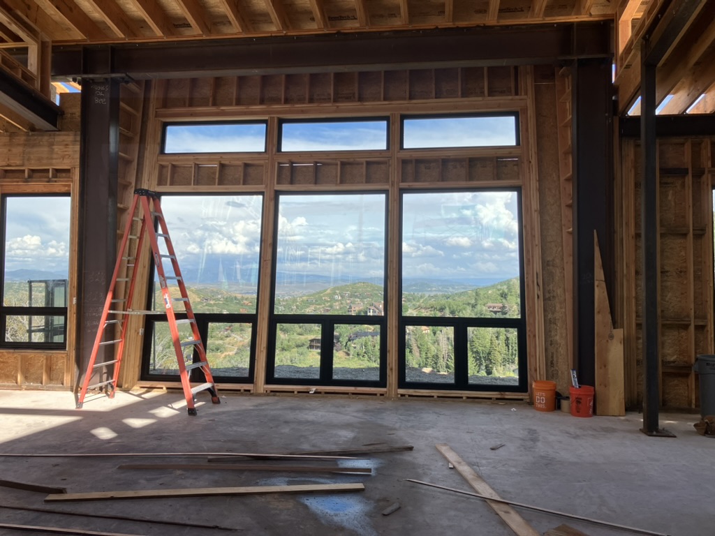 Exposed wooden framing showing the second floor structure of a home under construction by BBA Construction in Utah